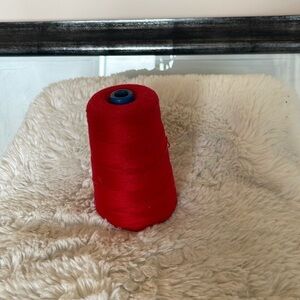 A spool of red cotton for sewing and crochet work basically new and vintage